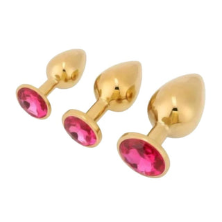 This is an image of the Luxurious Gold Princess Butt Plug 3 Piece Set X-Large for ultimate pleasure.