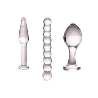 Pictured here is an image of 3 Piece Transparent Pyrex Glass Plug Anal Trainer Set For Men, featuring egg-shaped head, conical design, and beaded form for a variety of sensations.