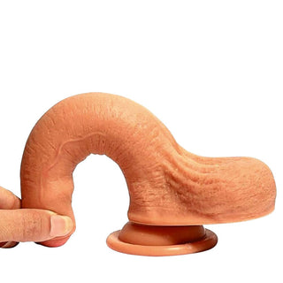 In the photograph, you can see an image of the silicone Uncircumcised 7 Inch Dildo With Testicles and Suction Cup, body-safe and easy to clean, suitable for vaginal or anal stimulation.