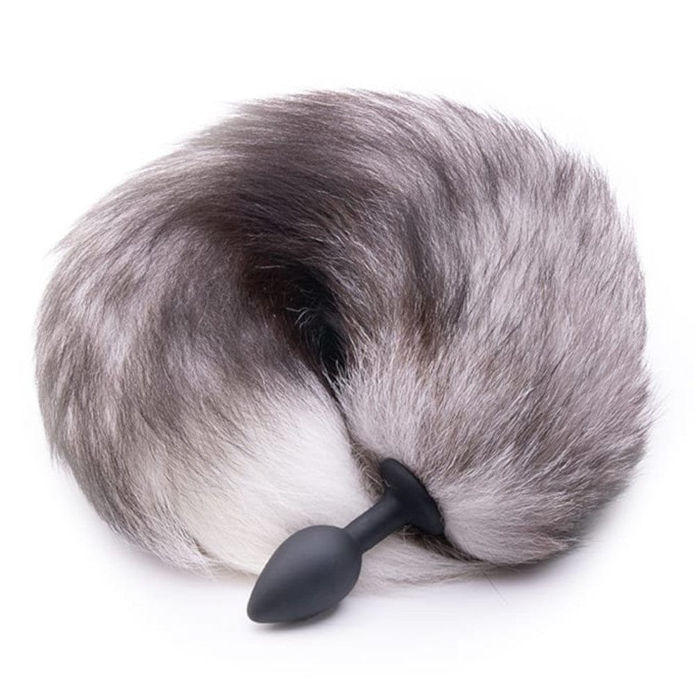 Observe an image of Feisty Greyback Fox Tail Plug 16 Inches Long, showcasing a lush gray fox tailpiece with the option of a silicone or stainless steel butt plug.