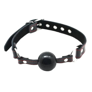 Check out an image of Drool Trainer Solid Rubber Ball Gag made of silicone and faux leather.
