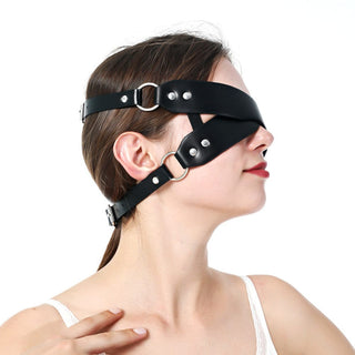 Premium faux leather blindfold ensuring absolute darkness for heightened sensory play.