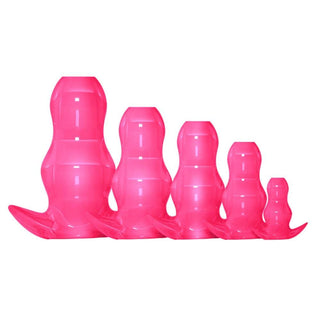 In the photograph, you can see an image of Take-A-Peek Silicone Hollow Plug in pink color with anchor-shaped flared base.