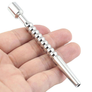 You are looking at an image of Stainless Cum Thru Urethral Sound with a tapered tip and 9 beads for a variety of sensations during use.