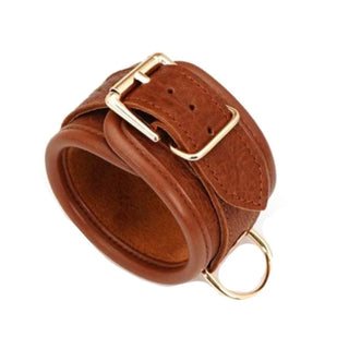 Brown leather wrist cuffs measuring 10.63 inches in length and 1.77 inches in diameter.
