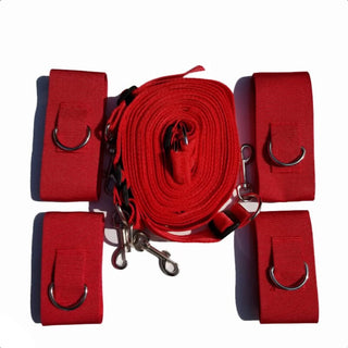 Nylon and metal bed bondage strap with hand and ankle cuffs.