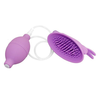 In the photograph, you can see an image of Max Pleasure Clitoris Pump showcasing soft silicone bristles within the suction cup for a gentle massage and battery-operated vibrator for tantalizing vibrations.