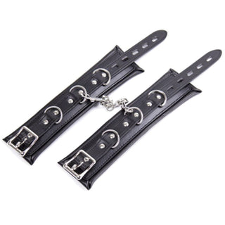 Displaying an image of Badass Leather Bondage Restraint with Hand Thigh Ankle Cuffs featuring a comfortable yet secure grip with varying lengths for ankle and handcuffs.