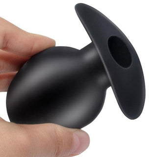 In the photograph, you can see an image of Anal Gaping Silicone Hollow Butt Plug specifications, featuring dimensions and material details.