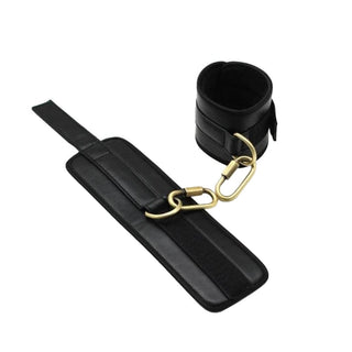 Black ankle bar with synthetic leather cuffs and adjustable velcro straps.