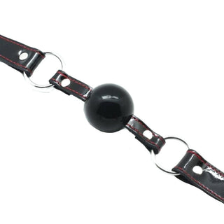 In the photograph, you can see an image of Drool Trainer Solid Rubber Ball Gag comfortable and safe to use.