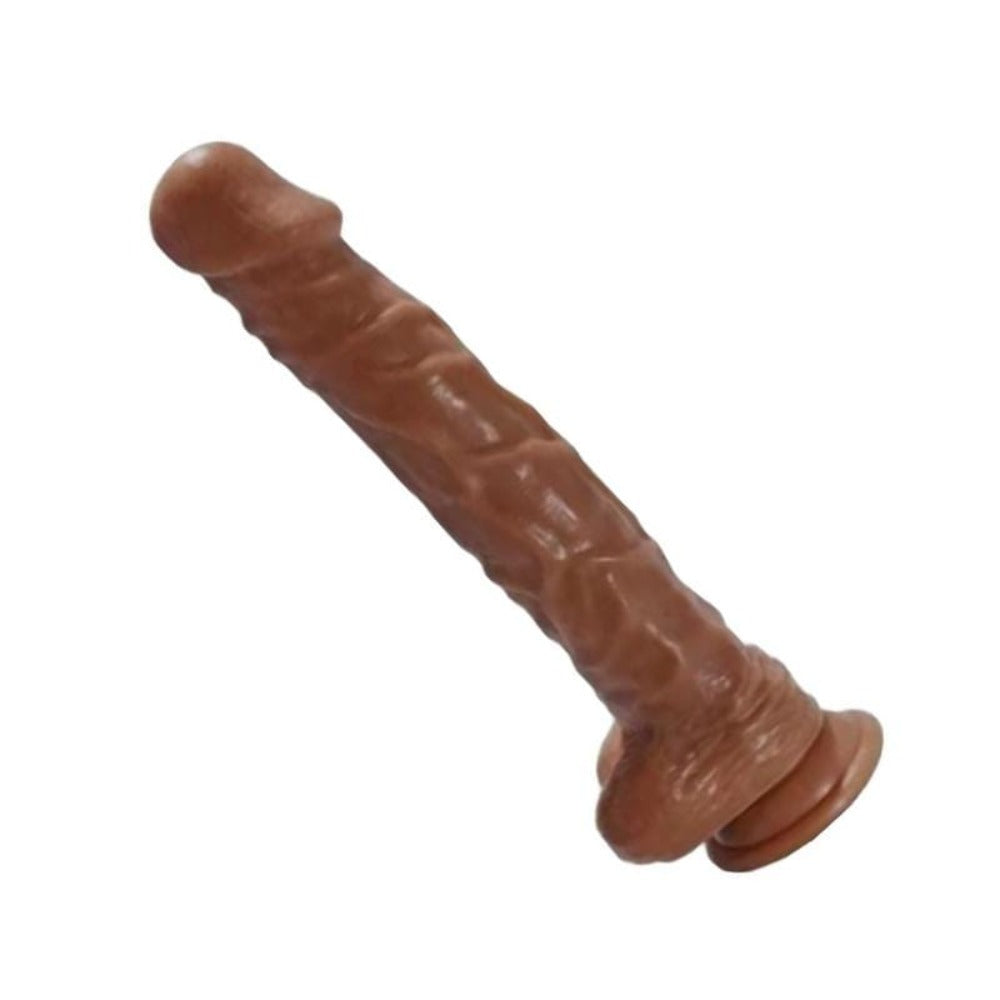 A photo of a 10 Inch Dildo With Balls and Suction Cup mounted on a smooth surface for hands-free pleasure.