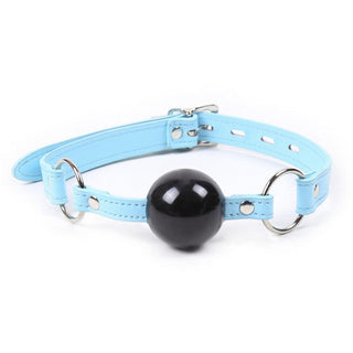 Featuring an image of Stay Silent Locking Gag Ball in black with purple and blue harness.