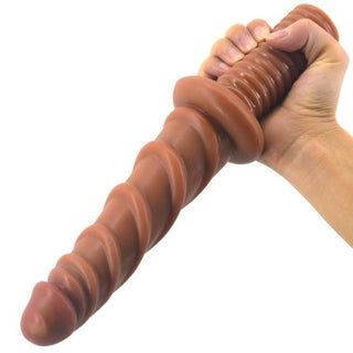 This is an image of Ribbed 11 Inch Toy Sword with a thickest width of 1.57 inches, thinnest width of 1.34 inches, and base width of 2.76 inches in brown silicone material.