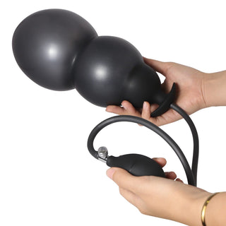 Observe an image of Inflatable Anal Massager Male Masturbation Toy, a black silicone massager with a pump length of 3.15 and a plug length of 5.12.