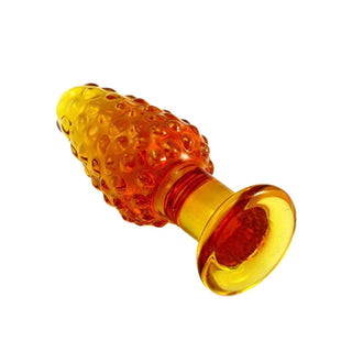 This is an image of a vivid yellow glass plug with irregular circles for added pleasure.