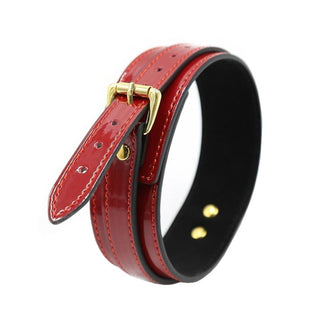 A well-crafted Leather BDSM Choker in red and gold with adjustable length and bold presence.