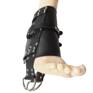 Observe an image of bondage ankle cuffs in black PU leather, offering a secure and pleasurable experience. With a length of 7.87 inches and adjustable belts, these cuffs provide a unique adventure in erotic exploration.