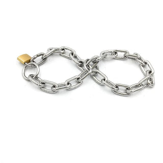 In the photograph, you can see an image of Stainless Adjustable Sex Hand Chains and Ankle Cuff in silver stainless steel material.