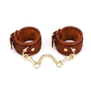 Antique-look wrist cuffs crafted from high-quality leather with D-rings for bondage play.