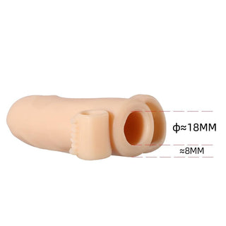 Presenting an image of Uncircumcised Extension Vibrating Cock Sleeve Stimulator in flesh and white colors with dimensions of 5.04 length and 1.34 width.