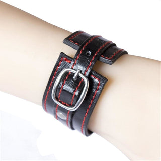 Leather Adjustable Padded Hand Cuff for Sex Restraint Play showcasing the belt-like locking mechanism and red stitching.