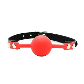 Featuring an image of Drool Overload Mouth Gag in red color with metal snap buttons.