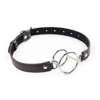 This is an image of Breath Easy Oral Bondage Accessory, featuring adjustable PU leather straps and stainless steel rings for dominance and submission play.