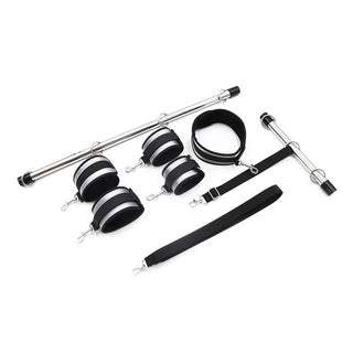 Displaying an image of Erotic Fantasy Adjustable Ankle BDSM Leather Spreader Toy Bar set with wrist and ankle cuffs, collar, and leash for BDSM play.