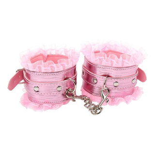 Picture of pink BDSM kit with collar, eye mask, whip, handcuffs, ankle cuffs, feather tickler, and clamps for unforgettable intimate experiences.
