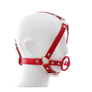 Observe an image of Ring Gag Harness in black and red colors made of PU Leather and metal with O-rings and chin strap for secure fit.