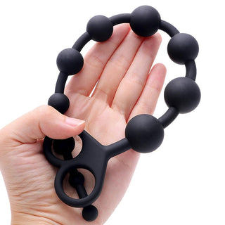 Check out an image of the Deep Sensations Silicone Long Ball String, highlighting its unique safety ring design for secure removal.