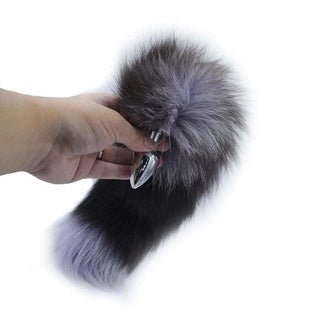 Feast your eyes on an image of Gray Fox Tail Plug 16 Inches Long featuring a sleek, smooth stainless steel structure.