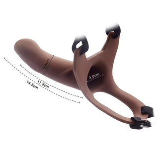 An image showcasing the Pegging Strap On For 5.7 Inch Couples set in beige and brown colors, perfect for steamy and pleasurable experiences.