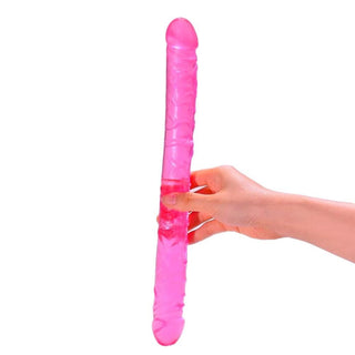 In the photograph, you can see an image of a 13.2-inch pink dildo with a 1.2-inch width, made of medical-grade silicone for safe and pleasurable use.