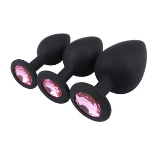 A set of three jeweled butt plugs in various sizes, perfect for beginners and experts in intimate play.
