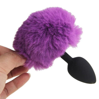 Playful and sensual black silicone bunny tail butt toy for heightened pleasure.