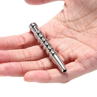 Pictured here is an image of Ribbed Stainless Hollow Penis Plug with ribbed texture for tantalizing sensations.
