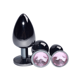 Check out an image of the metal butt plugs with a flared base showcasing a sparkling rhinestone for visual appeal.