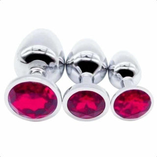Observe an image of a stainless steel butt plug with a pink acrylic crystal base.