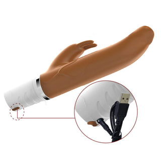 This is an image of Naughty Bunny Thrusting Vibrator Dildo, a rechargeable pleasure toy with USB charging capability for anytime use.