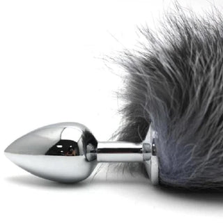 An image displaying the stainless steel butt plug with the ash gray and black faux fur tail for a luxurious touch.