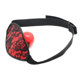 In the photograph, you can see an image of Bite the Ball Gag Mask with red floral lace cover and silicone gag for intimate play.