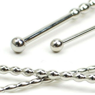 Silver-colored penis plug with a unique beaded texture for enhanced stimulation.