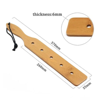 This is an image of BDSM paddle crafted from natural bamboo, adding a luxurious touch to intimate play.