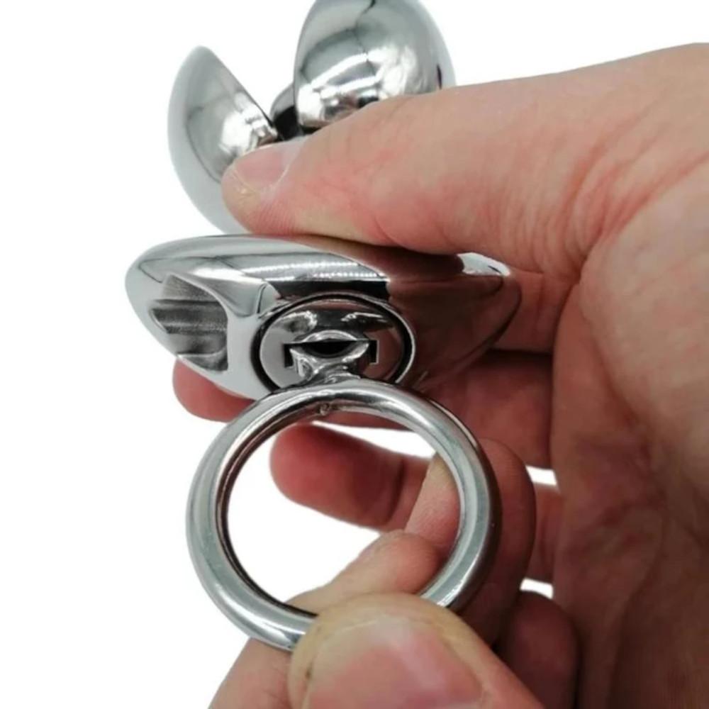 In the photograph, you can see an image of Dilate and Incarcerate Metal Locking Butt Plug, with a unique locking mechanism for added control and dominance.