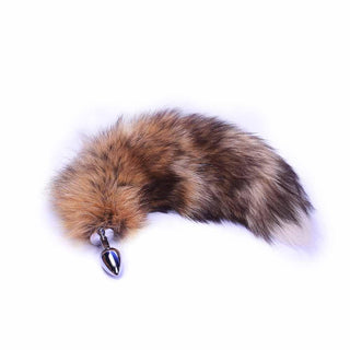 In the photograph, you can see an image of Flowing Wild Black and Brown Cat Fox Tail Animal Plug 25 Inches Long with luxurious brown and black faux fur tail.