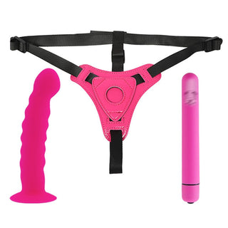 In the photograph, you can see an image of Pretty Pink Harness With Dildo, featuring black straps and a vibrant pink silicone dildo for tantalizing pleasure.