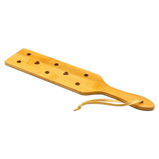 This is an image of a natural bamboo paddle, designed for comfort and reliability in BDSM play.