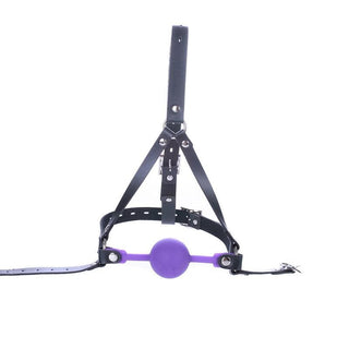 What you see is an image of Restrictive Purple Ball Gag with PU Leather harness in black and silicone gag in purple.
